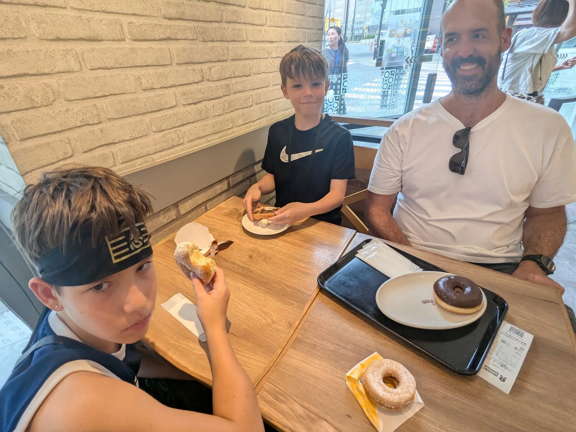 The family eating donuts at a donut shop in Hakone