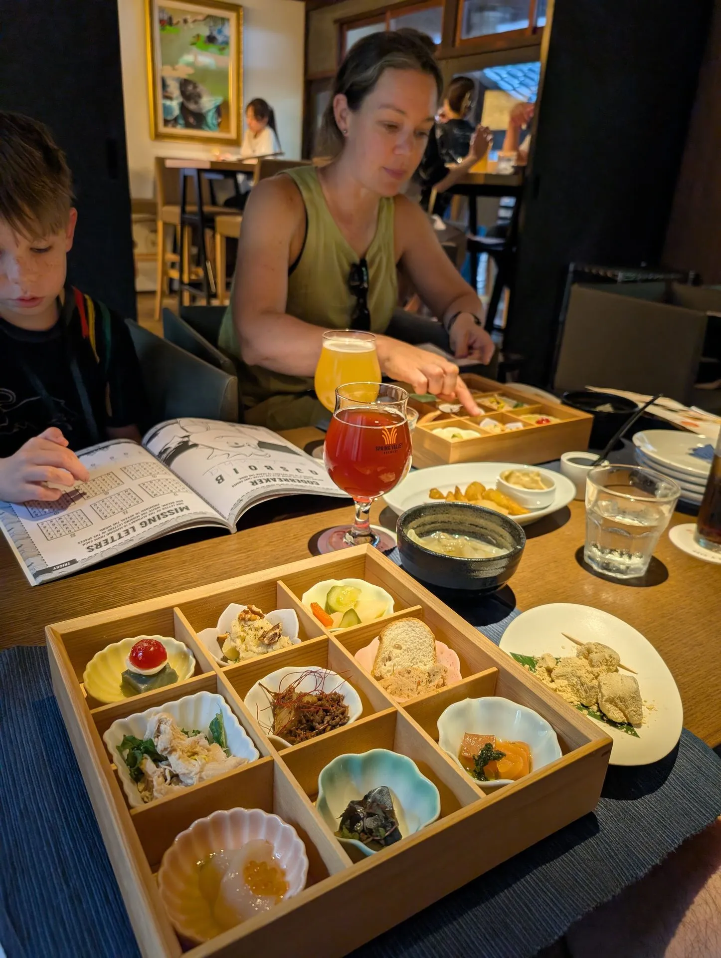 A kaiseki bento box served with a beer near Nishiki, Kyoto
