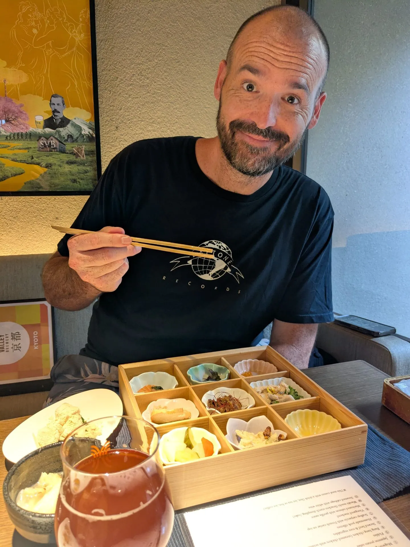 A kaiseki bento box being eaten with chopsticks at a restaurant near Nishiki, Kyoto