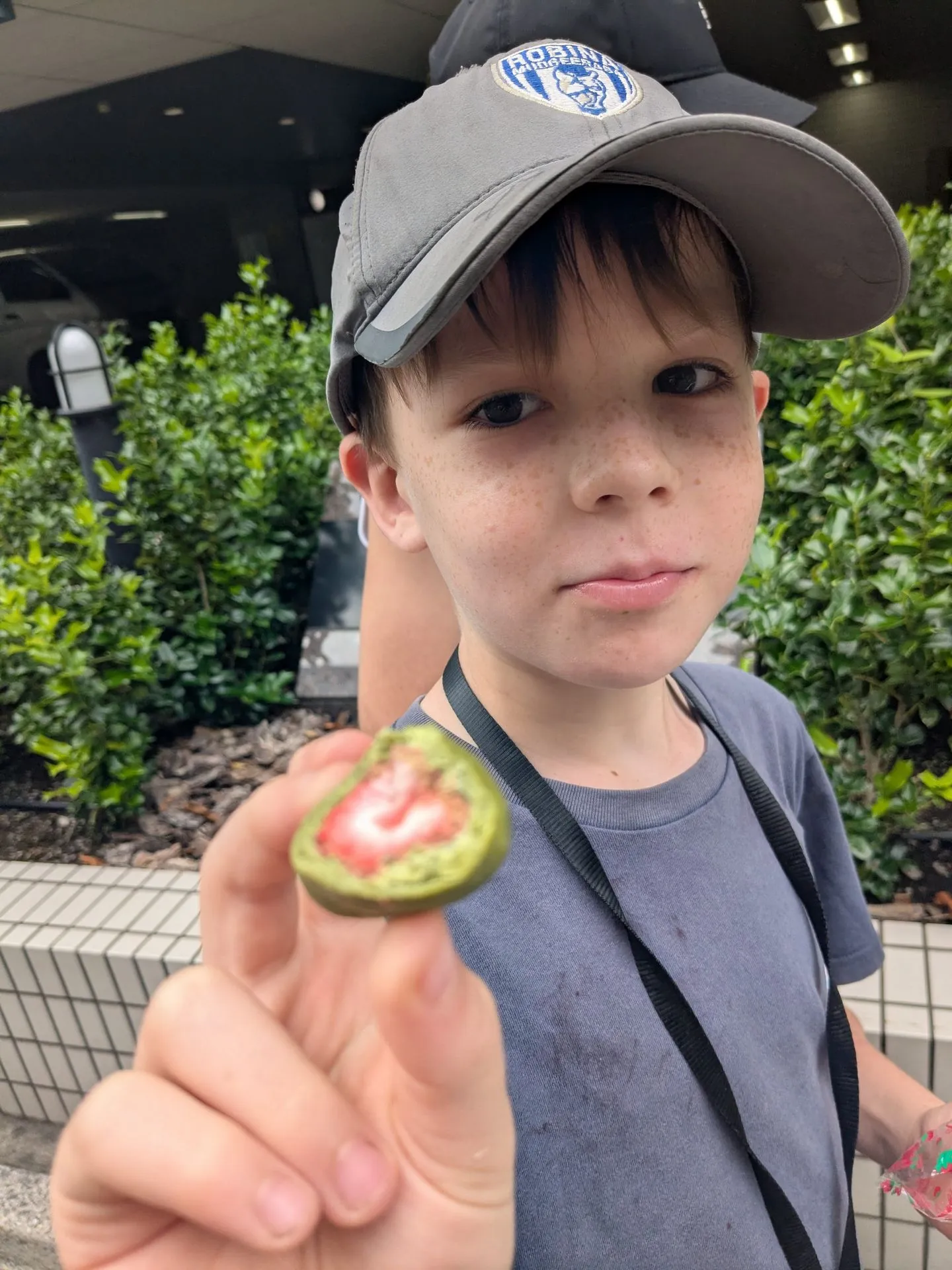 A child with strawberry matcha daifuku in Shibuya, Tokyo