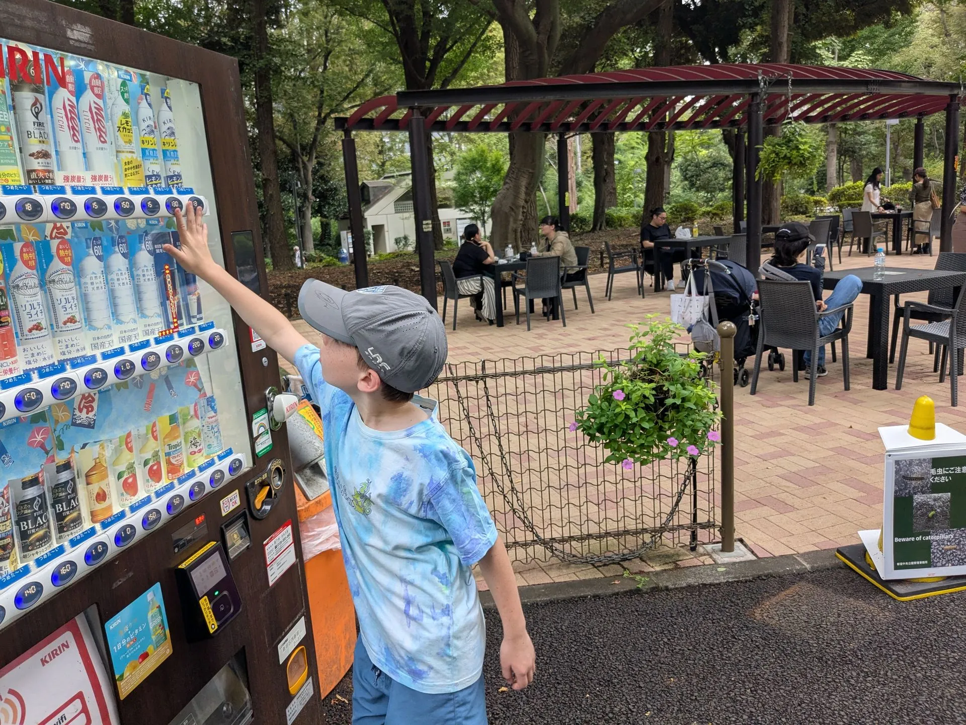 One of the boys choosing a drink at a vending machine near Shinjuku Gyoen, Tokyo