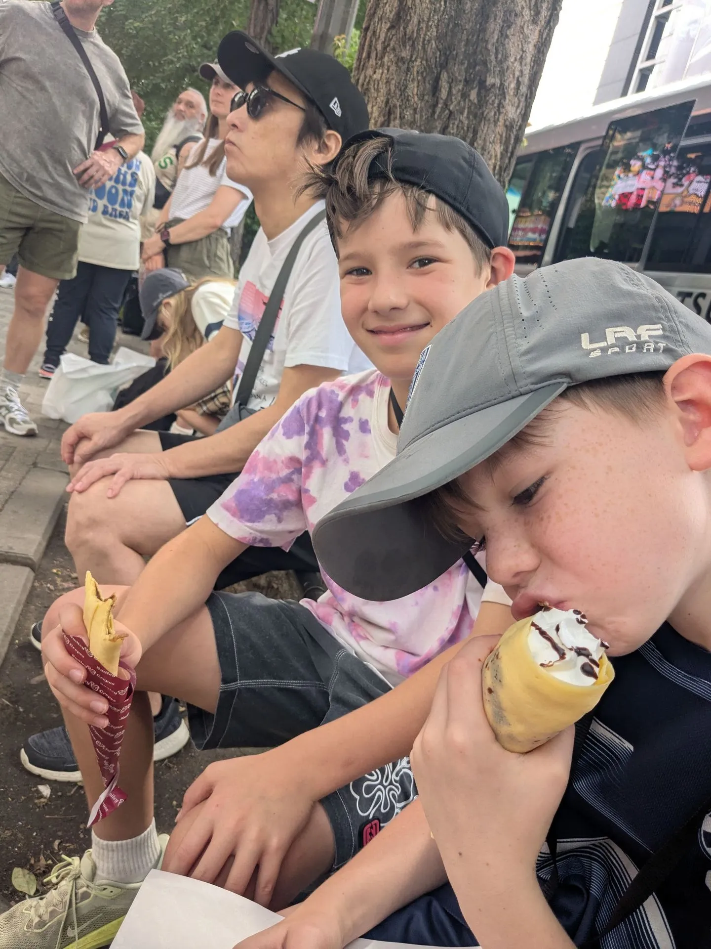 The boys eating crepes from Smiley Crepes in Ueno, Tokyo