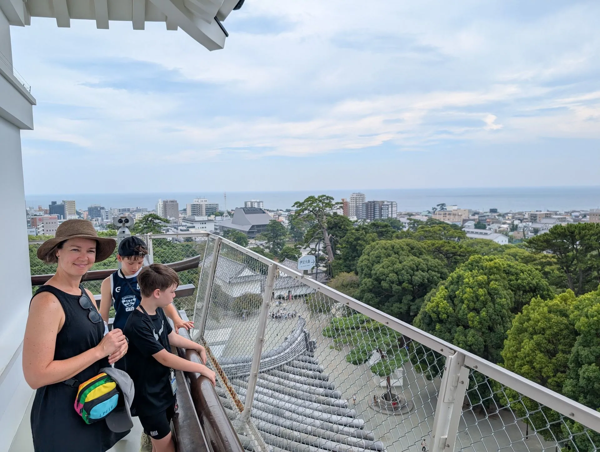 Family at the top of Odawara Castle tower with ocean view