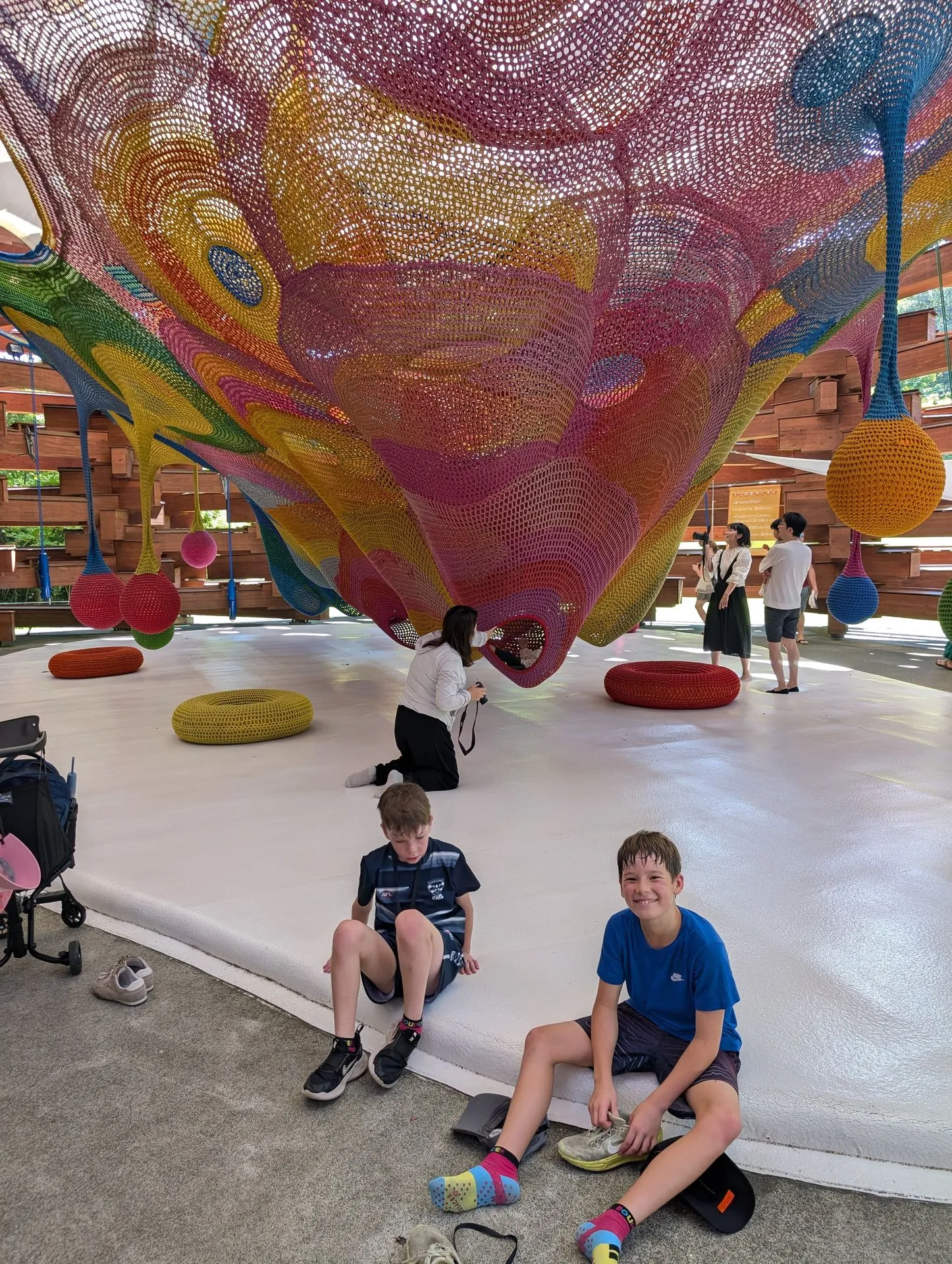 Kids climbing inside the large crochet net sculpture at Hakone Open Air Museum