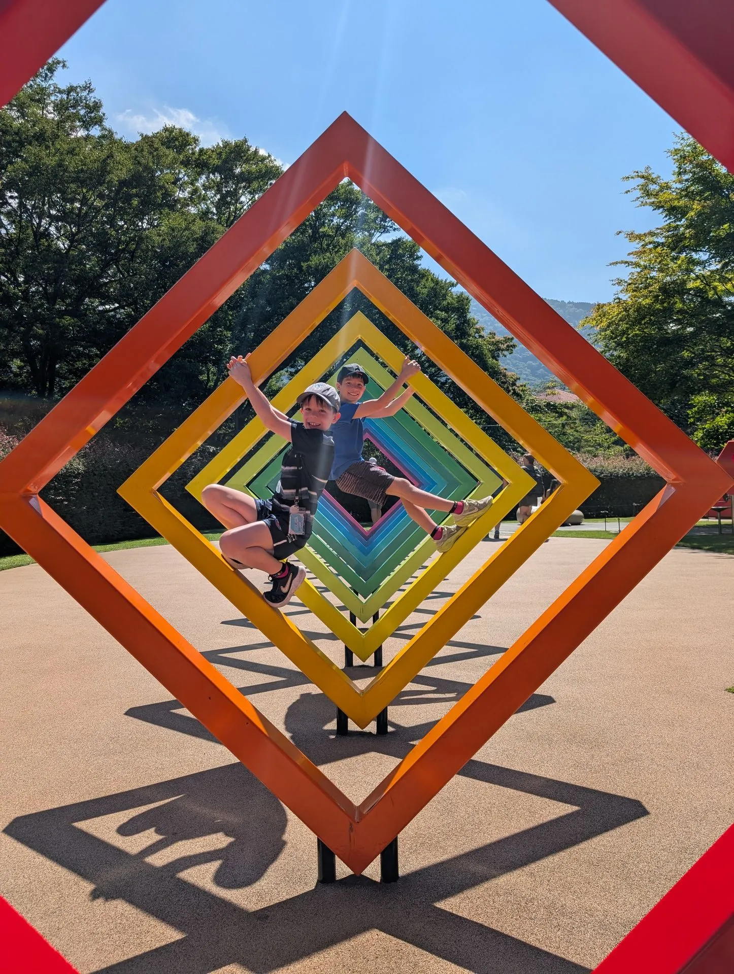 Kids playing inside the rainbow diamond-shaped sculpture at Hakone Open Air Museum