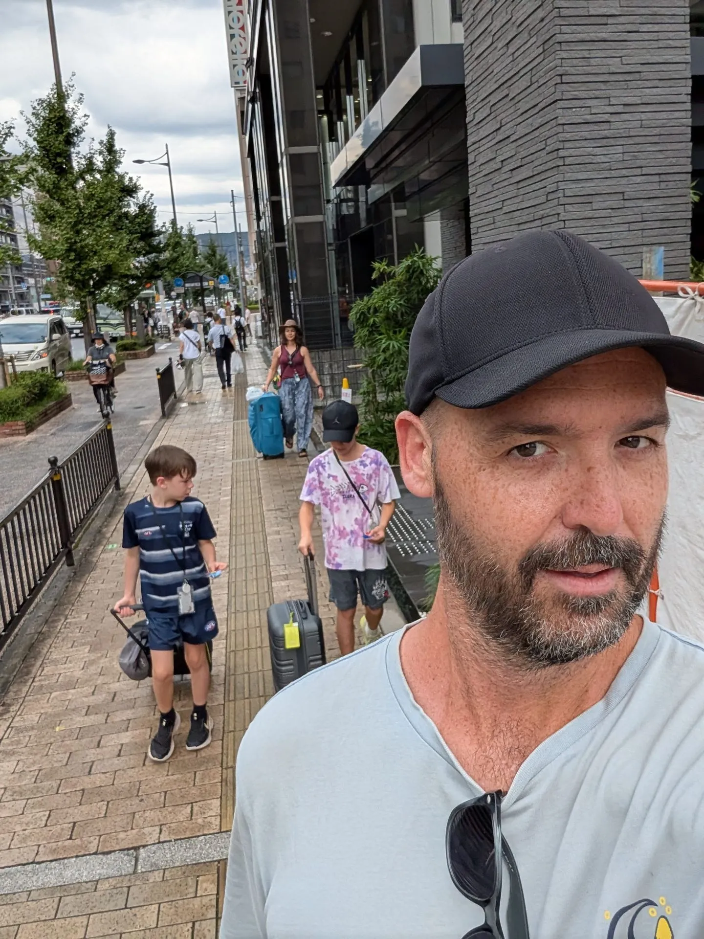 Matt with Lyndsie and the boys walking from the station to their hotel with luggage in Kyoto
