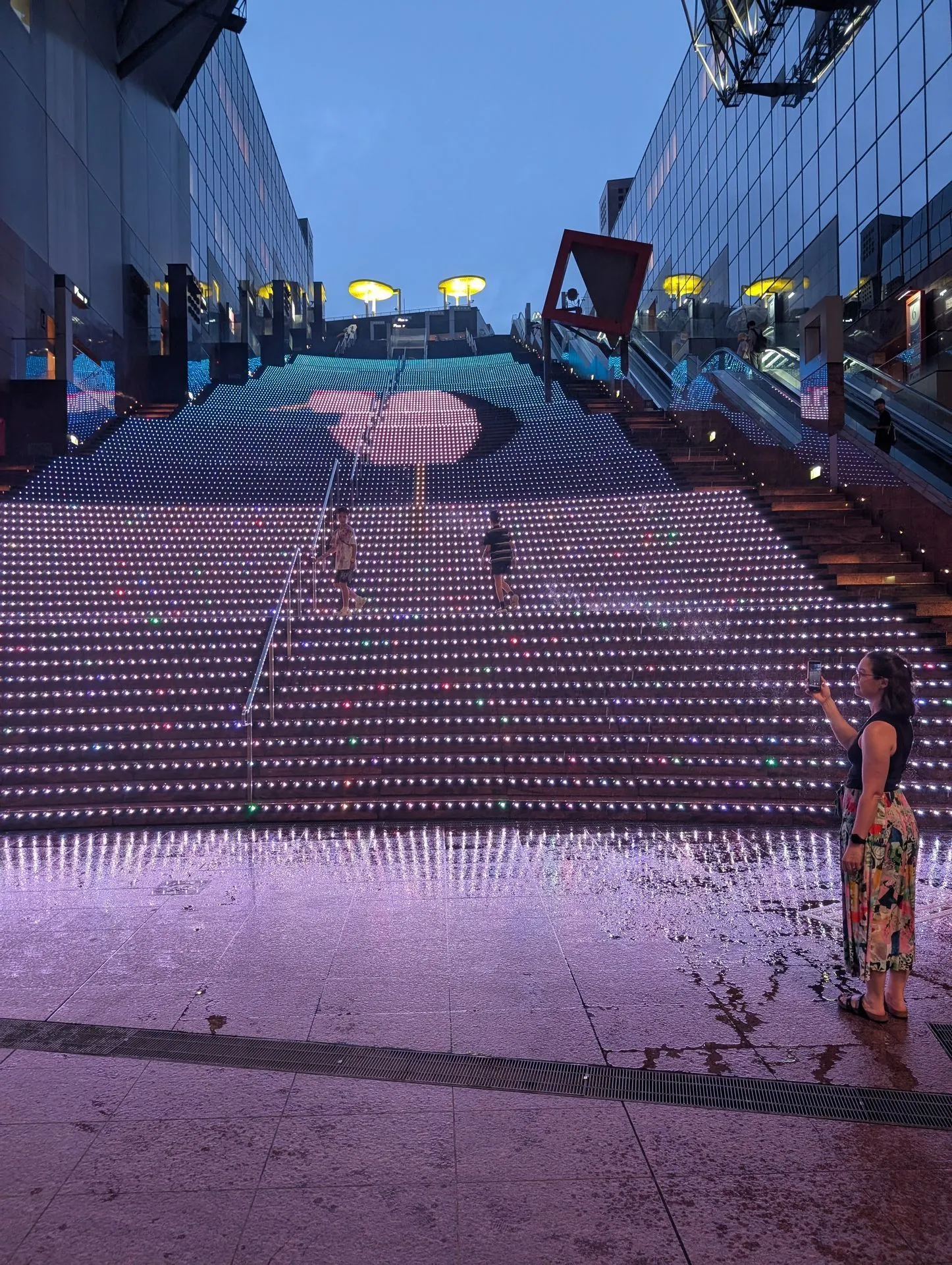 Kyoto Station LED staircase lit up at night with visitors on the steps