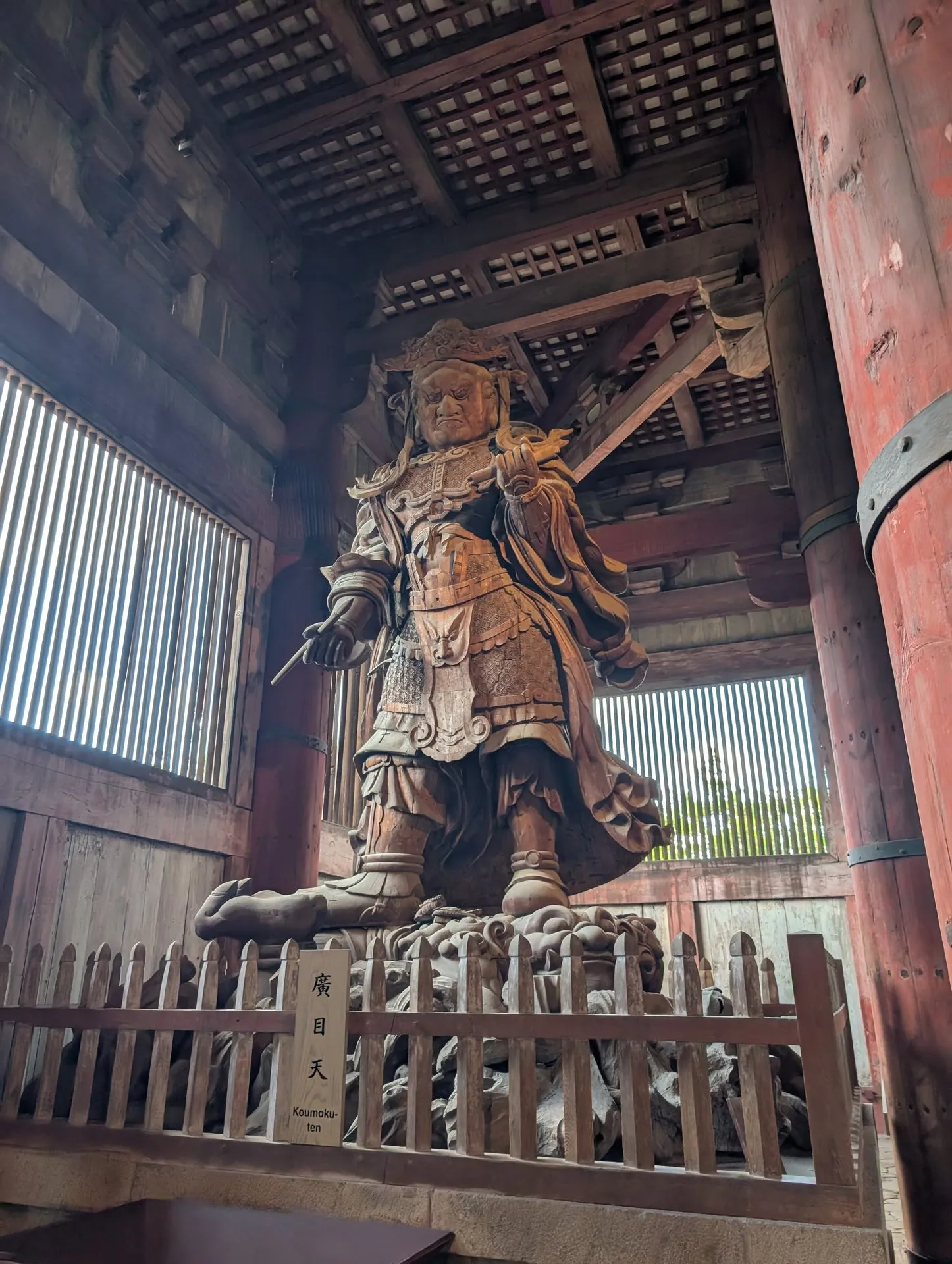 The towering wooden Koumoku-ten guardian deity statue inside Todai-ji temple, viewed from below