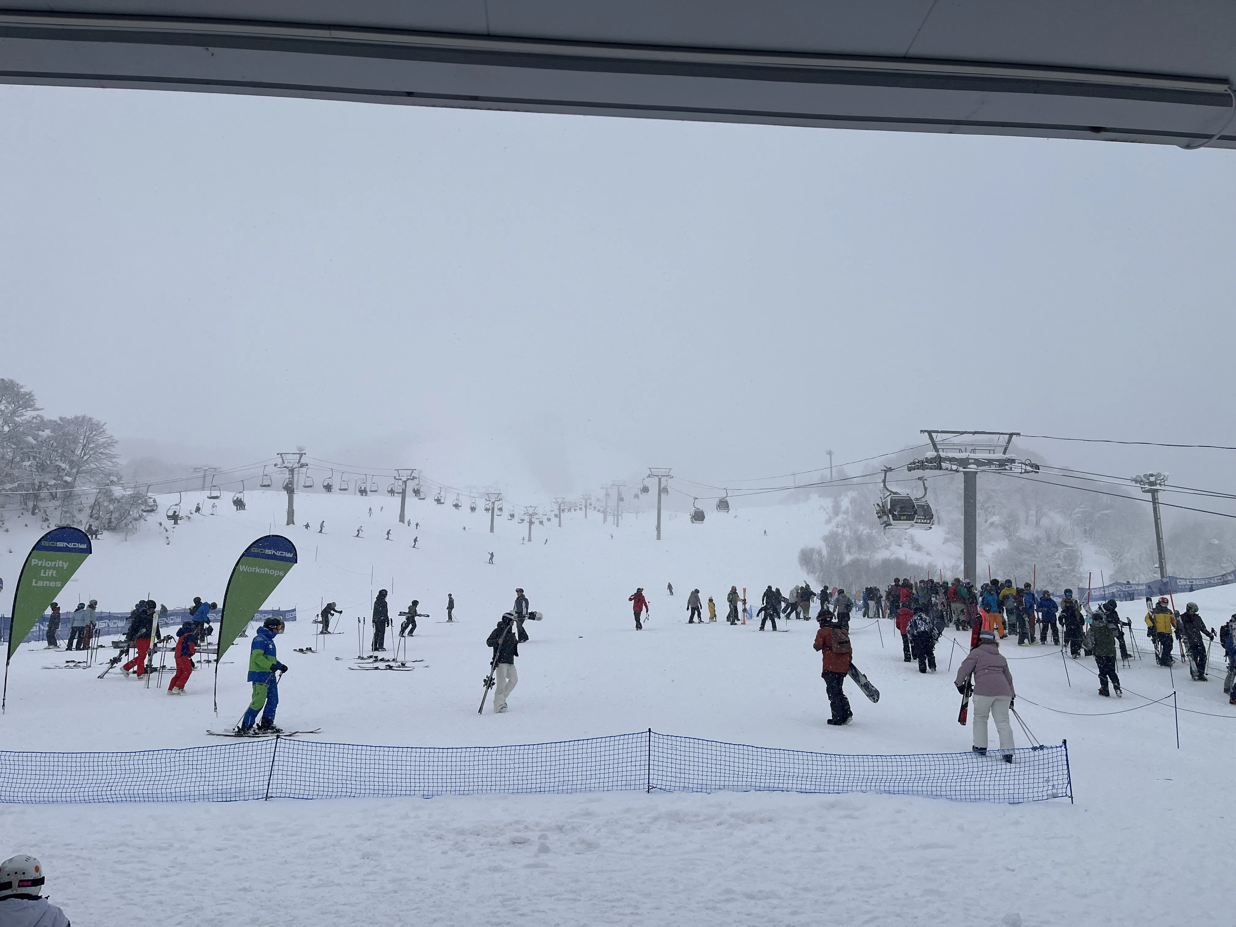 Skiers and chairlifts at the Grand Hirafu base area in Niseko
