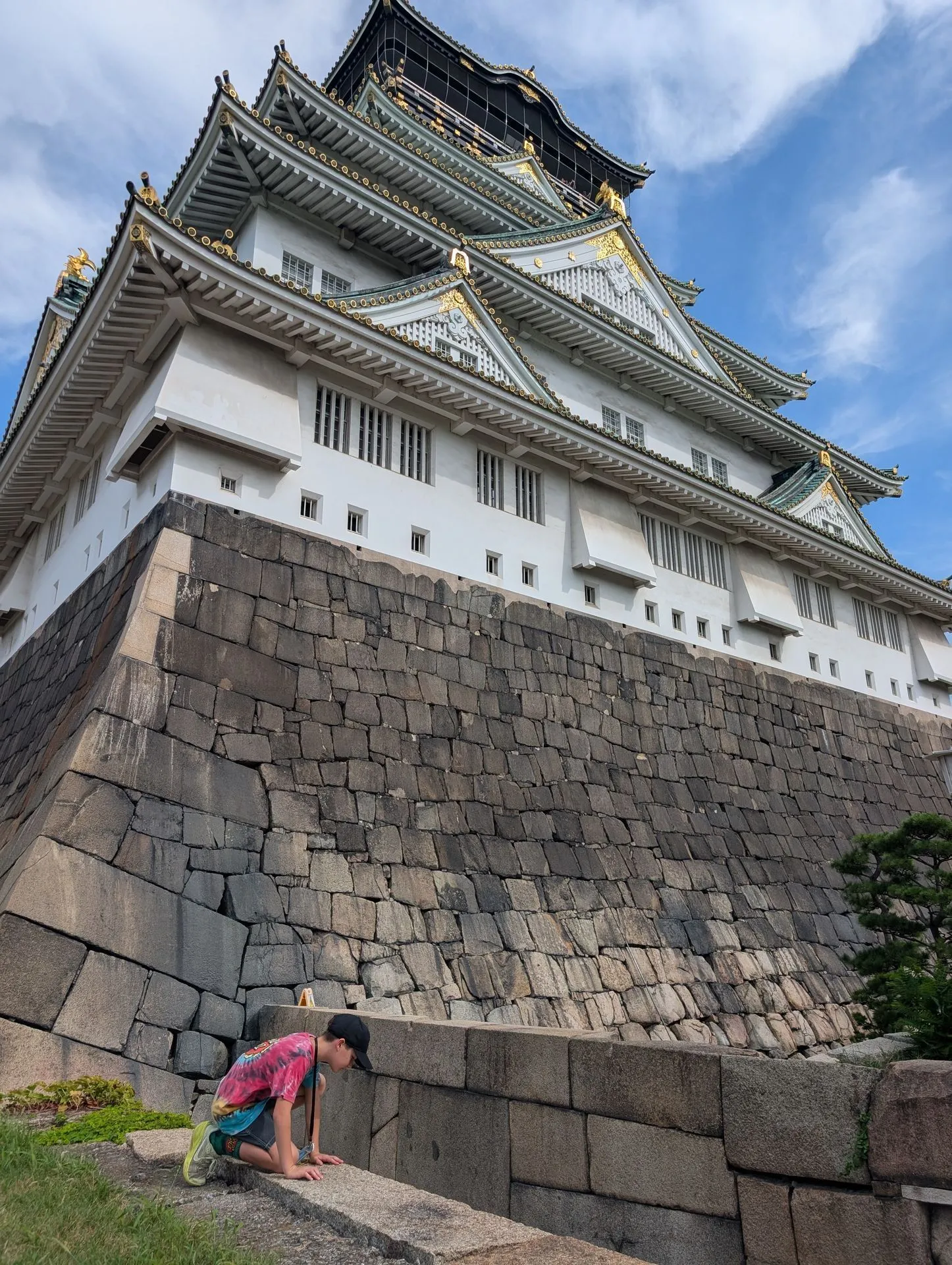 Child climbing on the massive stone walls of Osaka Castle