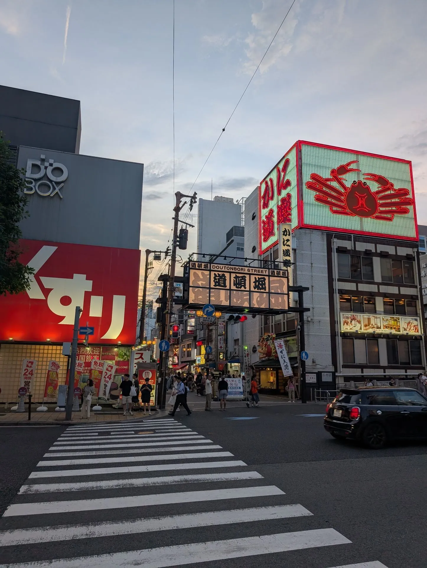 The giant mechanical crab sign above a Dotonbori restaurant in Osaka at evening