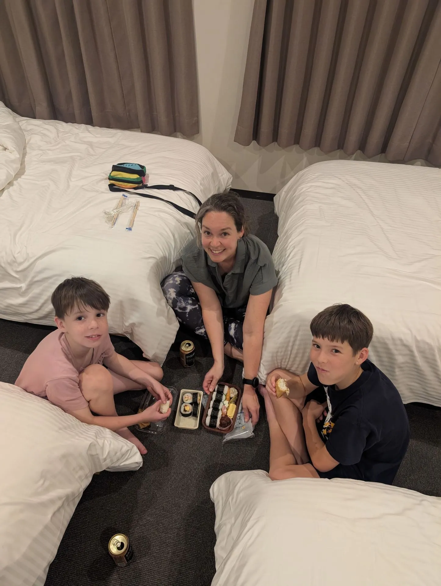 Lyndsie and the two boys eating a supermarket sushi dinner on the floor of our room near the airport on our first night in Osaka