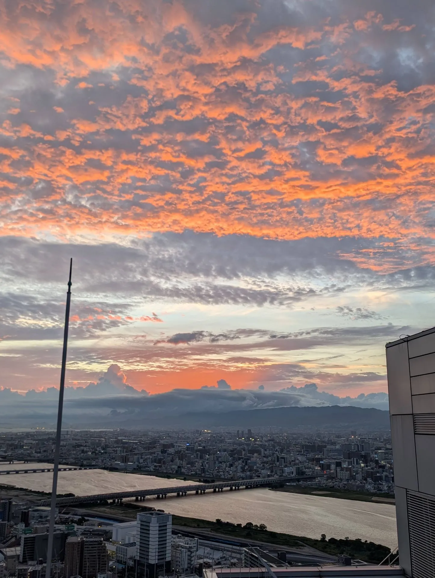 Dramatic sunset view from the Umeda Sky Building rooftop observatory in Osaka