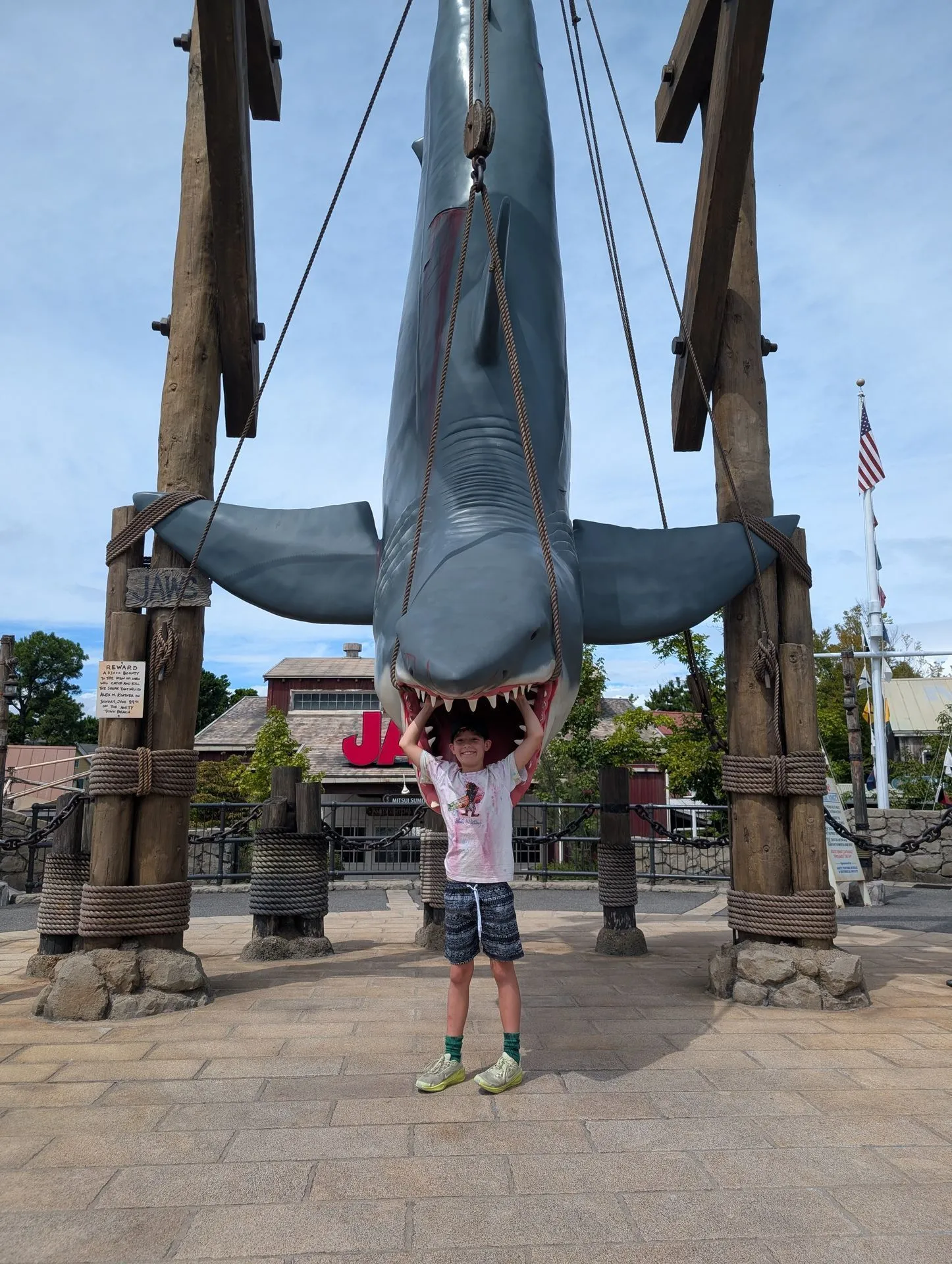 Family posing with the Jaws shark prop at Universal Studios Japan