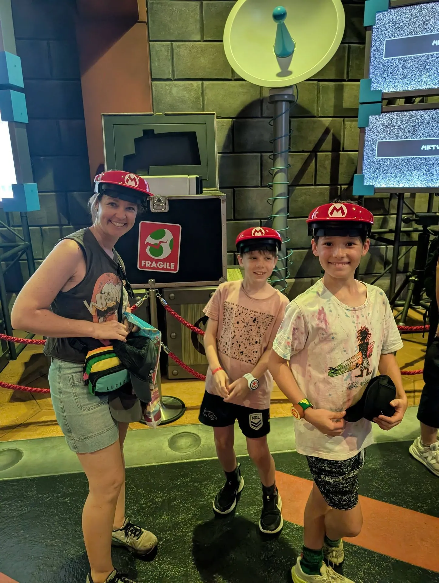 Family wearing Mario hats in Super Nintendo World at Universal Studios Japan