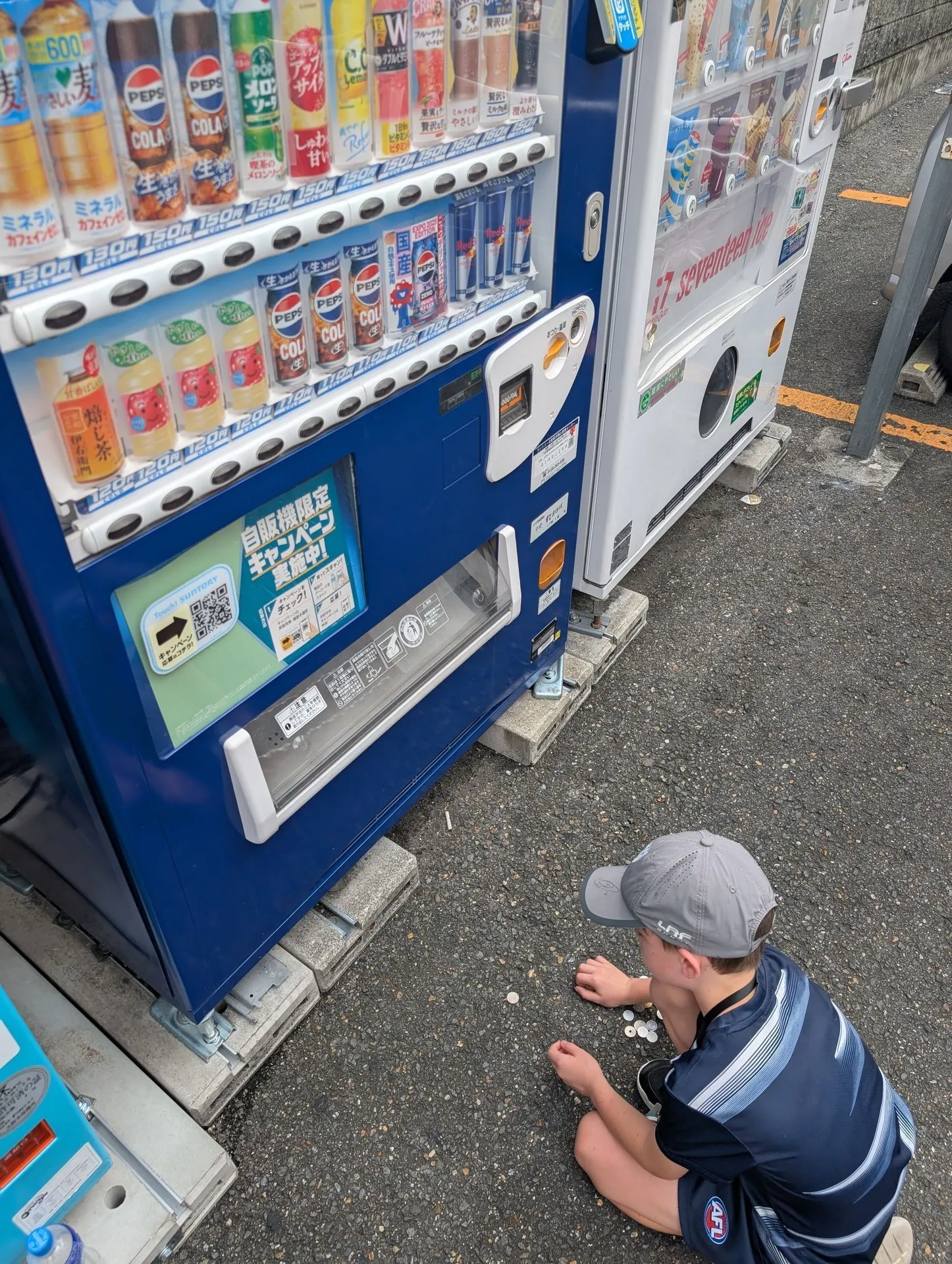 A row of drink vending machines on a street in Osaka