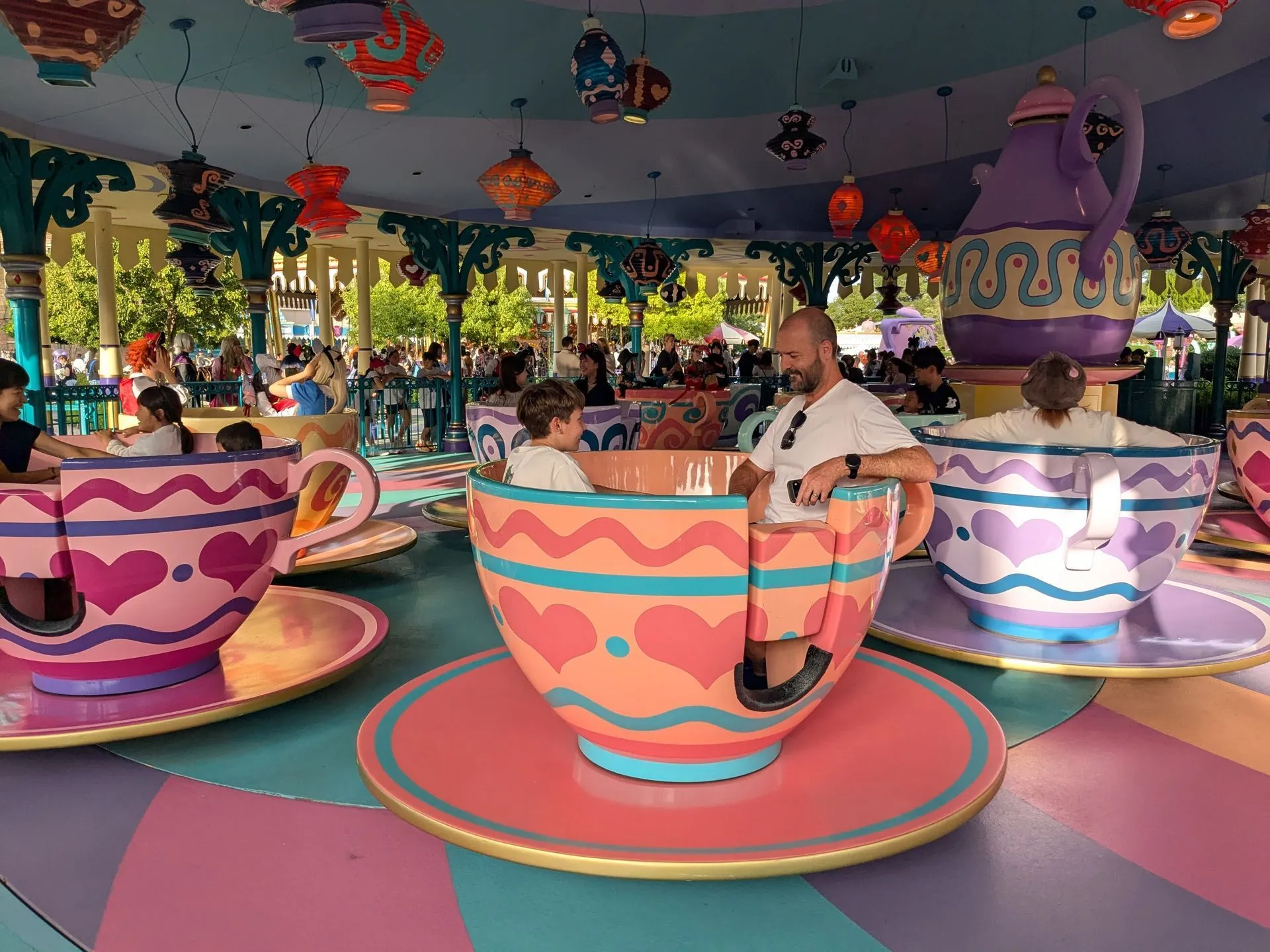 Family spinning on the Mad Hatter Tea Cups ride at Tokyo Disneyland
