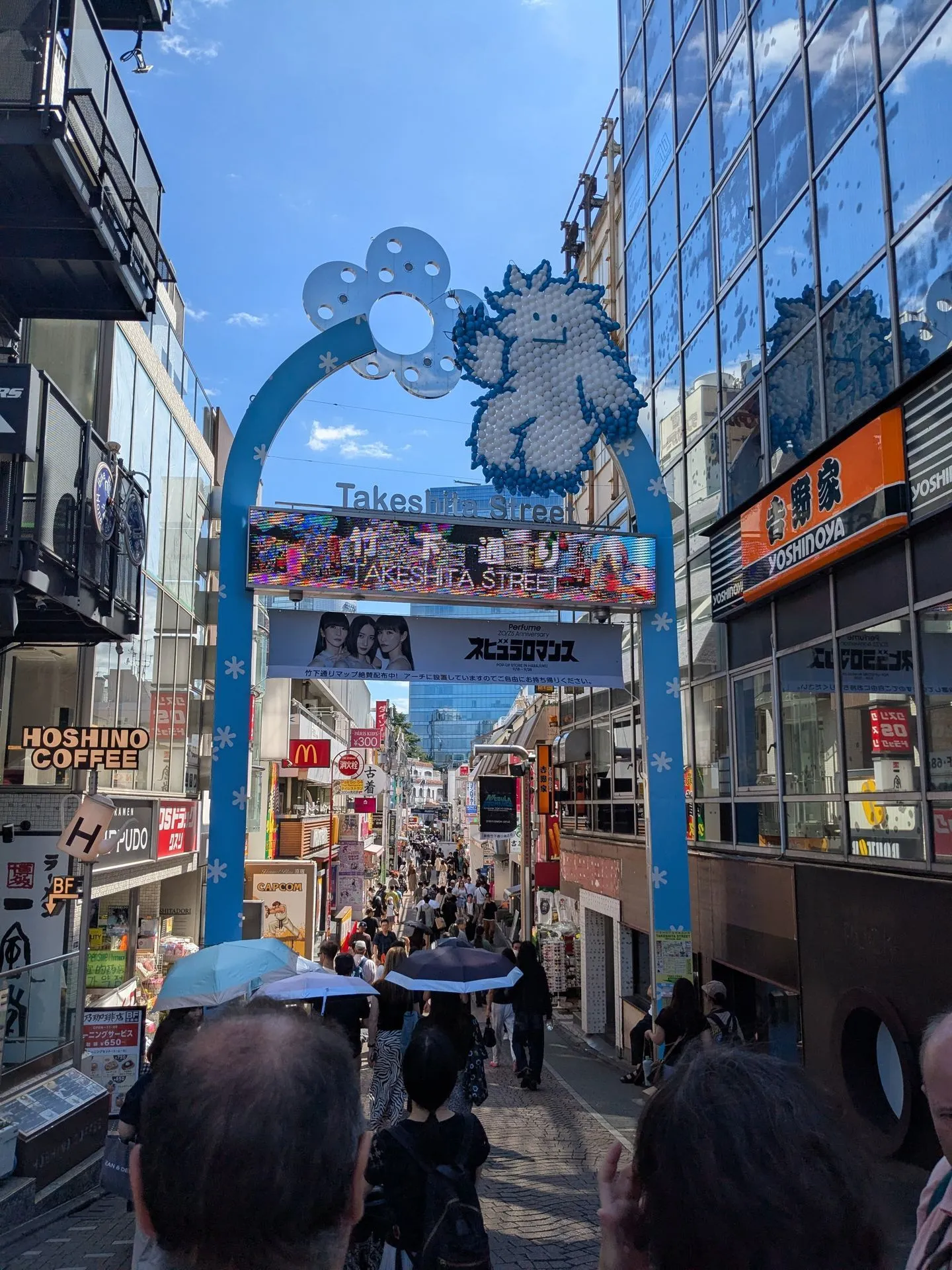 The entrance gate to Takeshita Street in Harajuku Tokyo with colourful shop signs