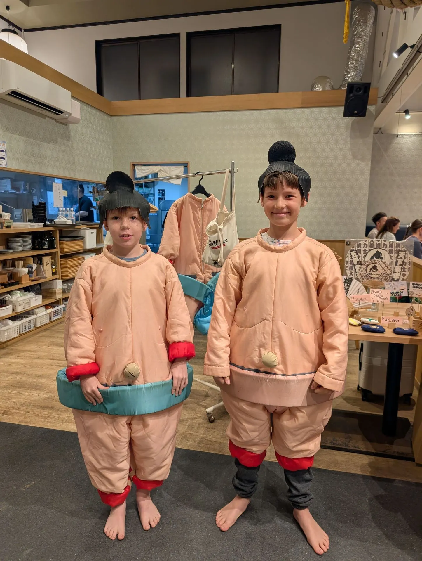 Kids in sumo costume dress-up at a Tokyo sumo experience show