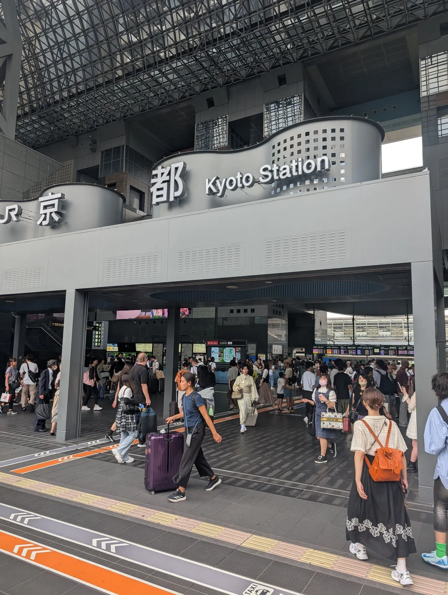 The entrance sign and crowd at Kyoto Station
