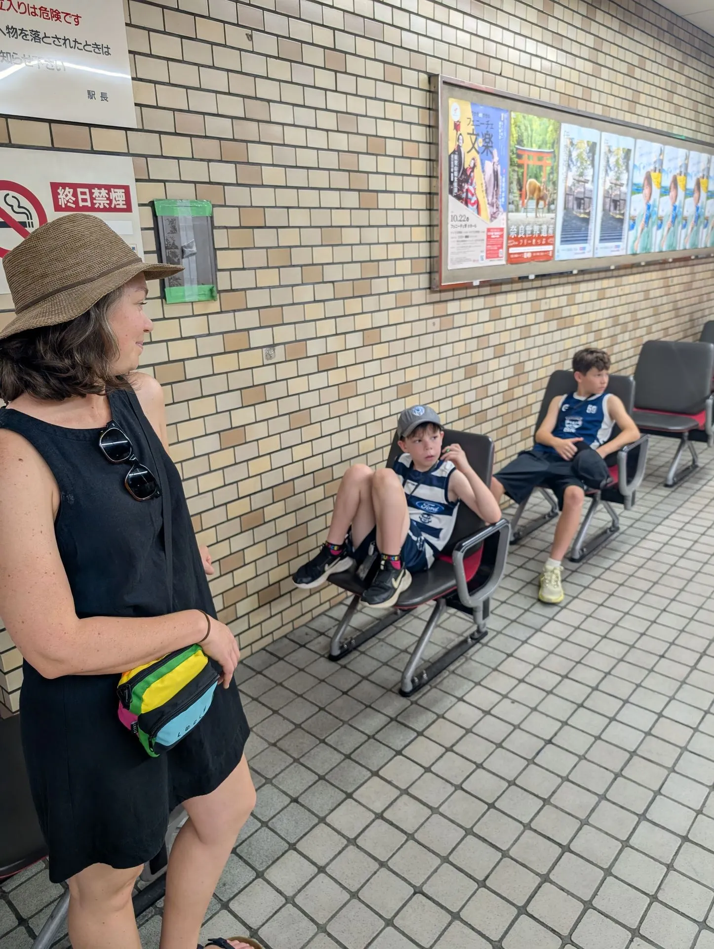 The family waiting on the platform at Namba subway station, Osaka